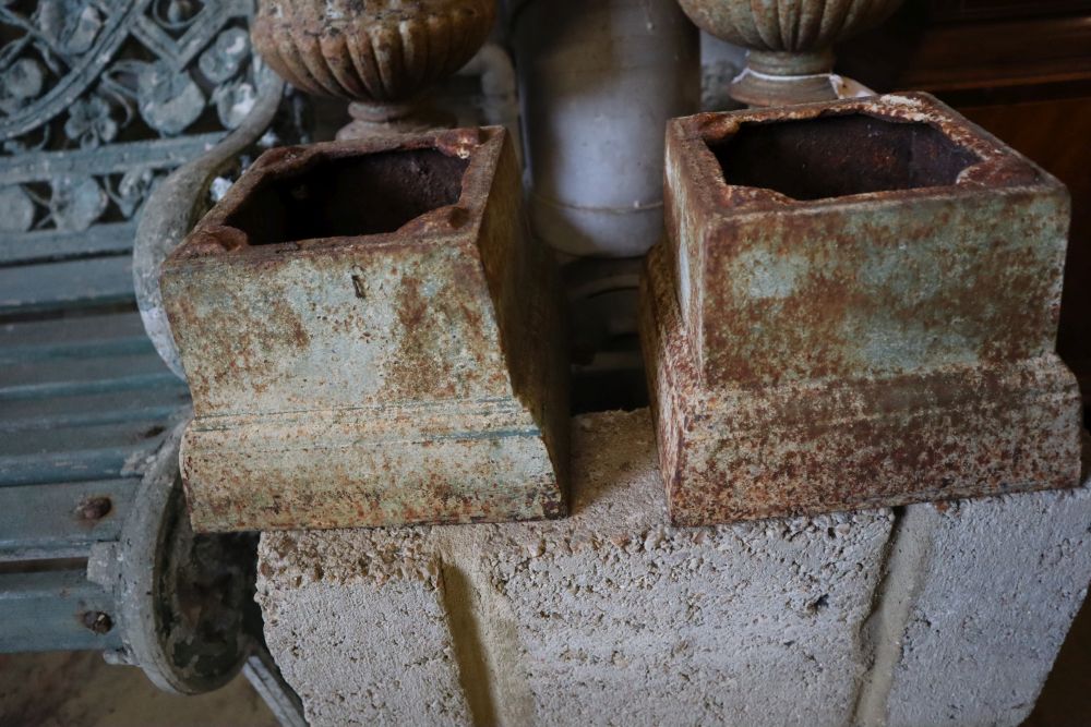 A pair of Victorian style cast iron campana garden urns on stands, height 49cm